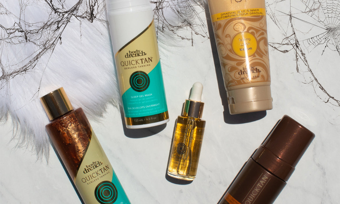 Body Drench Quick Tan self-tanning products arranged on a white surface with a spiderweb pattern, featuring tanning lotion, sleep gel mask, and tanning oil.